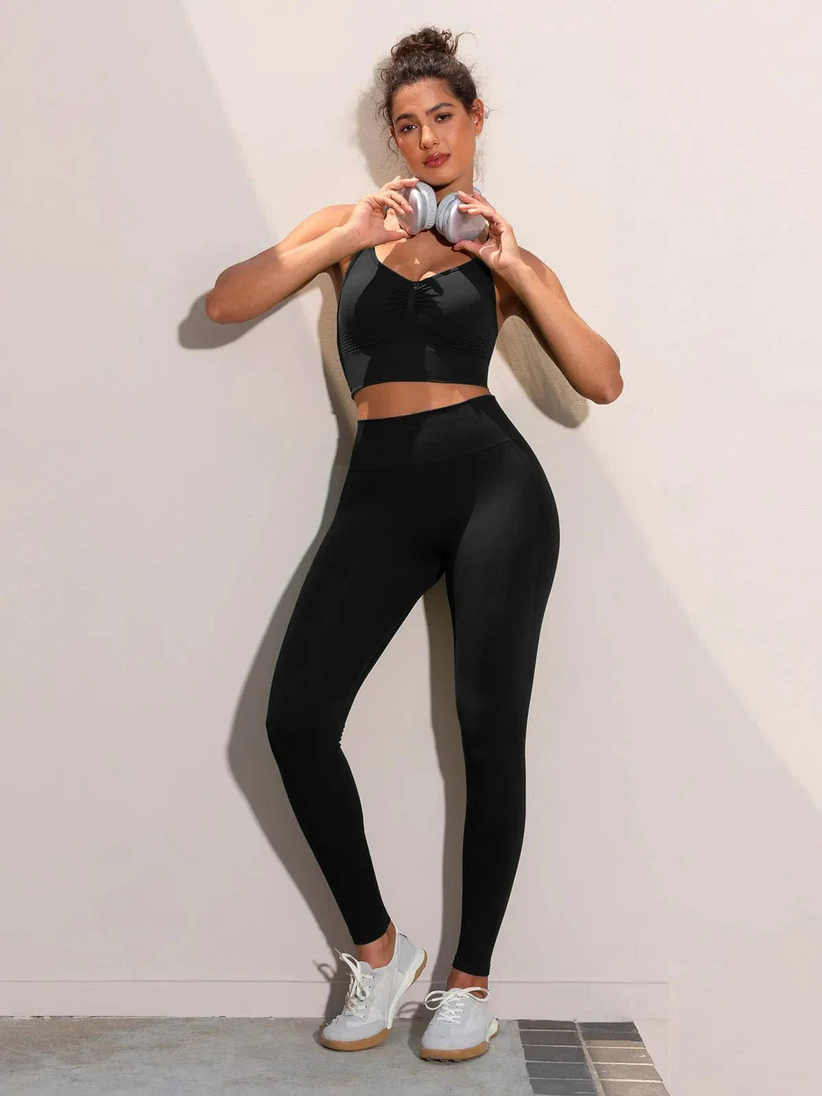 A model wearing a BRXL® Butt Lifting Seamless Bra Scrunch Leggings Set in